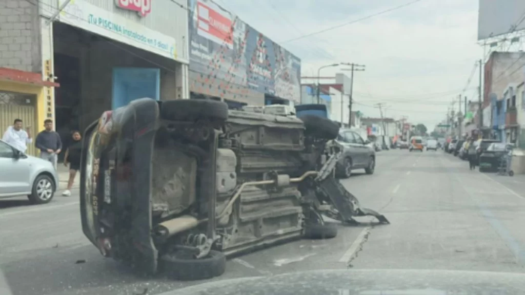 Taxi choca con dos camionetas y termina volcado